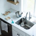 Stainless steel sink in a small white kitchen