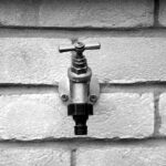 Outdoor faucet attached to a brick wall