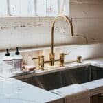 Stainless steel sink and faucet in a farmhouse kitchen