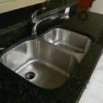 Two gauge stainless steel sinks with a stainless steel faucet